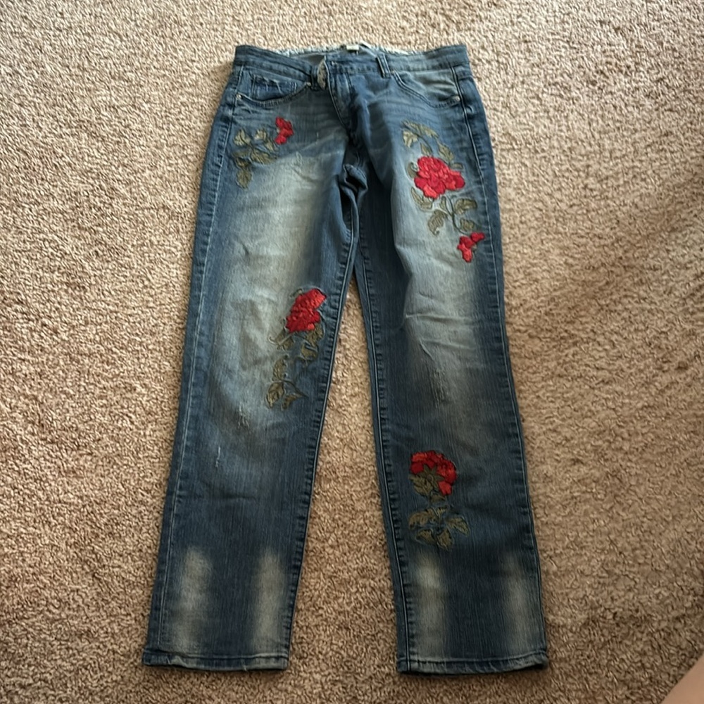 Denim Jeans with Flowers on both legs. Stretch material.